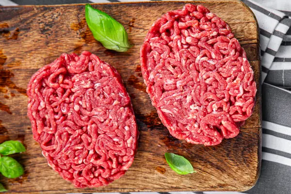 ground meat raw cutlet fresh beef meat hamburger eating cooking appetizer meal food snack on the table copy space food background rustic top view