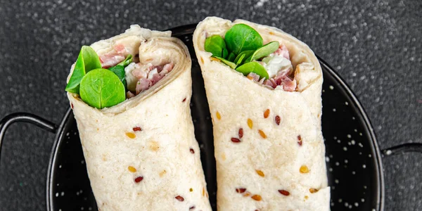 tortilla wrap ham, vegetable, cheese, lettuce fresh tasty healthy eating cooking appetizer meal food snack on the table copy space food background rustic top view