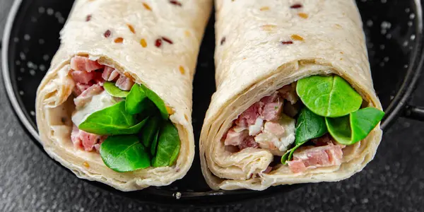 tortilla wrap ham, vegetable, cheese, lettuce fresh tasty healthy eating cooking appetizer meal food snack on the table copy space food background rustic top view