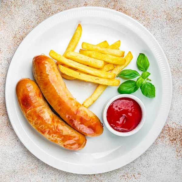 fried sausages and french fries fast food meat and potatoes tasty fresh eating cooking appetizer meal food snack on the table copy space food background rustic top view