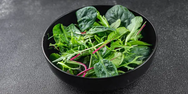 Healthy salad mix, leaves micro green, juicy snack healthy eating cooking appetizer meal food on the table copy space food background rustic top view keto or paleo diet vegetarian vegan