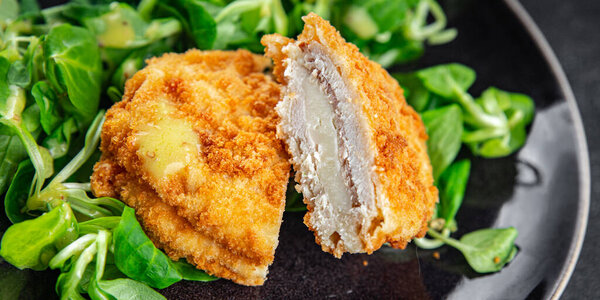 cutlet cordon bleu chicken meat, ham, cheese natural fresh appetizer meal food snack on the table copy space food background rustic top view