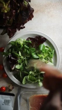Jamon salatası yeşil yaprak marul, domates, salata sosu aperatif yemek atıştırmalığı fotokopi masasında uzay yemeği arka plan kırsal üst görünüm keto veya paleo diyeti