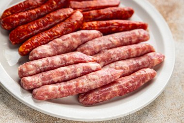 Çiğ sosis, domuz eti, tavuk, kuzu eti, taze lezzetli gurme yemek arkaplanı masanın kırsal kesiminde fotokopi alanı.