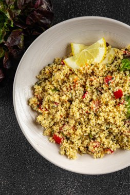 Sebzeli tabbouleh bulgur kuskus. Lezzetli vejetaryen ve vejetaryen yemekleri. Arka planda yemek.