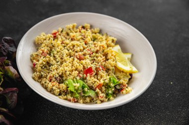 Sebzeli tabbouleh bulgur kuskus. Lezzetli vejetaryen ve vejetaryen yemekleri. Arka planda yemek.
