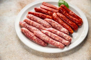 Çiğ sosis, domuz eti, tavuk, kuzu eti, taze lezzetli gurme yemek arkaplanı masanın kırsal kesiminde fotokopi alanı.