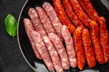 Çiğ sosis, domuz eti, tavuk, kuzu eti, taze lezzetli gurme yemek arkaplanı masanın kırsal kesiminde fotokopi alanı.