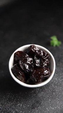 Kurutulmuş kuru erik, kurutulmuş erik ve gurme yemek arka planda masada rustik gıda fotokopi alanı keto ve paleo diyet vejetaryen ve vejetaryen gıda