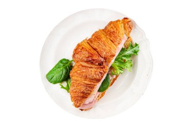 Sandviç kruvasan jambon, peynir, yeşil yaprak salatası lezzetli gurme yemek arkaplanı masa kırsal yiyeceklerin üst görünümü fotokopi alanı.