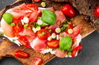 Jambon, domates, yeşillik taze lezzetli gurme yemek arkaplanı masa kırsal yiyeceklerin üst görünümü fotokopi alanı.