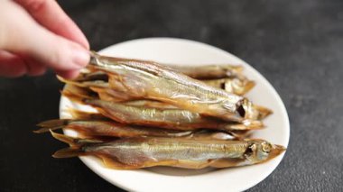 Balık tütsülenmiş kapelinli sprat yemeği taze lezzetli gurme yemek arka planda masa rustik gıda üst görünüm fotokopi alanı pesseeter diyet