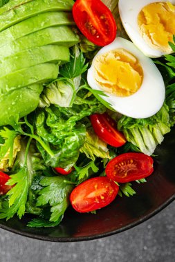 Avokado salatası, haşlanmış yumurta, domates, yeşil yaprak, marul, sebze yemeği taze lezzetli gurme yemek arka planda masanın üstünde rustik yiyecekler fotokopi alanı keto ve paleo diyeti vejetaryen yemekleri