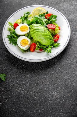 Avokado salatası, haşlanmış yumurta, domates, yeşil yaprak, marul, sebze yemeği taze lezzetli gurme yemek arka planda masanın üstünde rustik yiyecekler fotokopi alanı keto ve paleo diyeti vejetaryen yemekleri