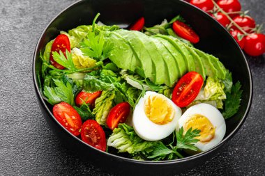 Avokado salatası, haşlanmış yumurta, domates, yeşil yaprak, marul, sebze yemeği taze lezzetli gurme yemek arka planda masanın üstünde rustik yiyecekler fotokopi alanı keto ve paleo diyeti vejetaryen yemekleri