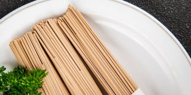 Soba karabuğdaylı erişte çiğ taze yemek Asya mutfağı masanın üstünde rustik yiyecekler fotokopi alanı