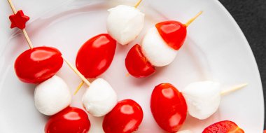 Caprese salatası kanape domates ve mozzarella, fesleğen iştah açıcı sebze taze gurme yemek arkaplanı masa rustik gıda üst görünümü fotokopi alanı