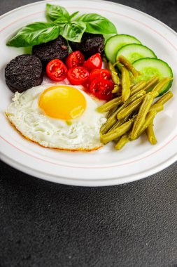 İngiliz kahvaltısı sahanda yumurta, kara puding, sebzeler, fasulye taze gurme yemek arkaplanı masanın kırsal kesiminde fotokopi alanı.