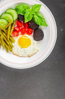 İngiliz kahvaltısı sahanda yumurta, kara puding, sebzeler, fasulye taze gurme yemek arkaplanı masanın kırsal kesiminde fotokopi alanı.