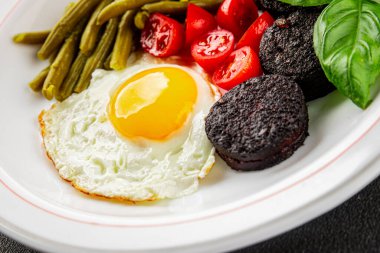 İngiliz kahvaltısı sahanda yumurta, kara puding, sebzeler, fasulye taze gurme yemek arkaplanı masanın kırsal kesiminde fotokopi alanı.