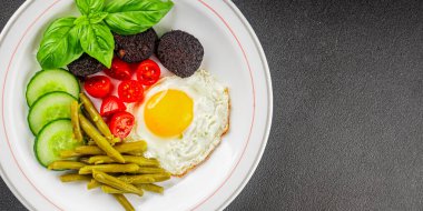 İngiliz kahvaltısı sahanda yumurta, kara puding, sebzeler, fasulye taze gurme yemek arkaplanı masanın kırsal kesiminde fotokopi alanı.