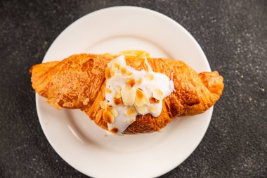 Kruvasan bademi taze pişmiş tatlı tatlı tatlı aperatif lezzetli gurme yemek arkaplanı masa kırsal yiyeceklerin üst görünümü fotokopi alanı.