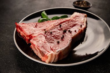 Çiğ biftek T-bone taze et prim biftek aperatif taze lezzetli gurme yemek arka planı masa rustik gıda üst görünüm fotokopi alanı