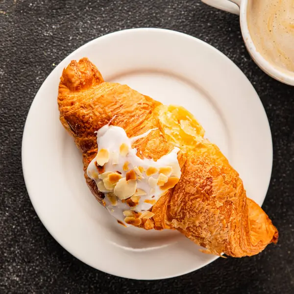 Kruvasan bademi taze pişmiş tatlı tatlı tatlı aperatif lezzetli gurme yemek arkaplanı masa kırsal yiyeceklerin üst görünümü fotokopi alanı.