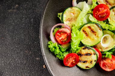 Salata ızgara kabak, domates, marul, lezzetli aperatif lezzetli lezzetli gurme yemek arkaplan masa üzerinde rustik gıda üst görünüm fotokopi alanı keto ve paleo diyet vegan ve vejetaryen gıda