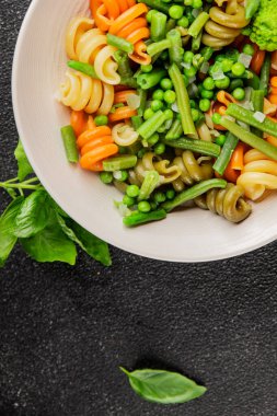Trottole makarna sebzeler yeşil bezelye, yeşil fasulye, kohlrabi lahanası, brokoli ikinci yemek lezzetli çerez taze lezzetli gurme yemek arka planı masa kırsal gıda üst görünüm boşluk