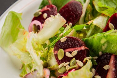 Beet salad green leaf lettuce vegetables natural product tasty snack fresh delicious gourmet food background on the table rustic top view copy space keto and paleo diet vegan and vegan food