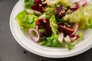 Beet salad green leaf lettuce vegetables natural product tasty snack fresh delicious gourmet food background on the table rustic top view copy space keto and paleo diet vegan and vegan food
