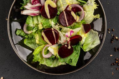 Beet salad green leaf lettuce vegetables natural product tasty snack fresh delicious gourmet food background on the table rustic top view copy space keto and paleo diet vegan and vegan food