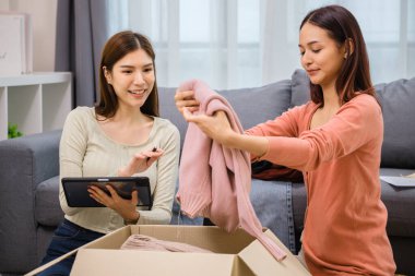 Bir grup arkadaş, kıyafetlerini bir bağış kutusuna yerleştiriyor ve paketliyor. Toplum desteği ve hayır kurumlarına bağış yapıyor.