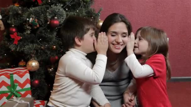 Two Attractive Kids Wispering Womans Ears Christmas Tree Little Boy — Stock Video
