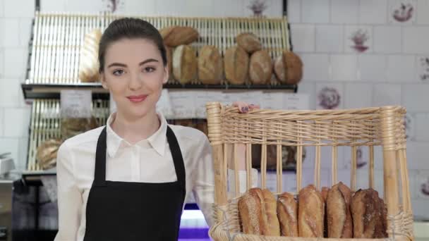 卖女孩的人提供面包 咖啡厅或面包店内年轻的微笑面包师提供新鲜的面包 马卡龙 新的面包店 咖啡店的分类总是一个 — 图库视频影像