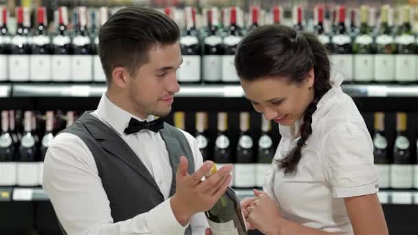 Säljare Supermarket Erbjuder Flaska Rött Vin Till Leende Kvinna Vacker — Stockvideo