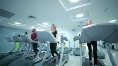 Grup oturumları koşu bandı üzerinde. Spor salonunda treadmill çalışan insanlar. Spor giyim ve spor salonunda bir dikiz sporcular çalışan sporcular