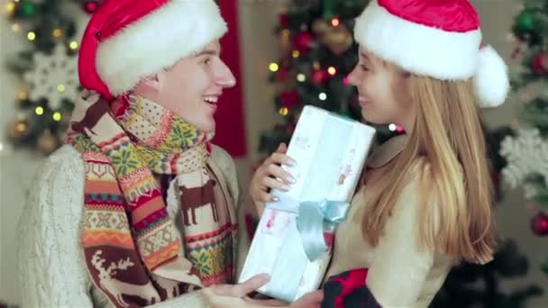 Loving Couple Dressed Sweater Scarf Holding Gifts Christmas Furnished Room — Stock Video