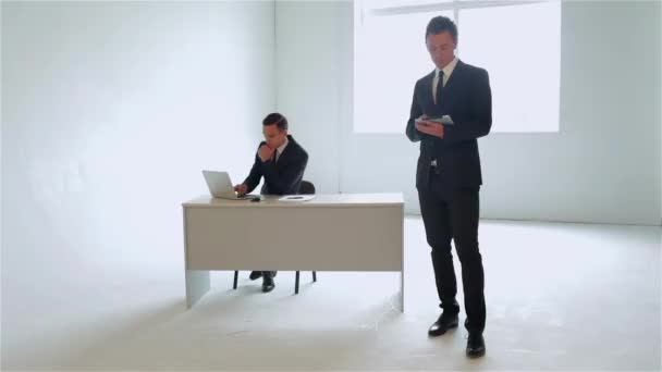 Ein Geschäftsmann Steht Uns Gegenüber Und Hält Das Tablet Der — Stockvideo