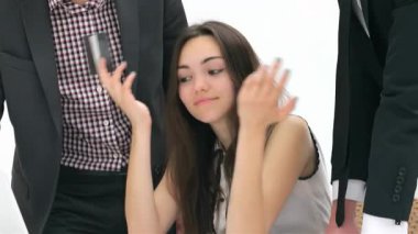 Kendine güveni olan genç bir kadın, canlı bir tartışma, takım çalışması ve işbirliği sergileyen iş adamları tarafından çevrelenmiş durumda. Sahne, kurumsal bir ortamın dinamik enerjisini yakalıyor. Kadın fikirlerini ifade ederken...