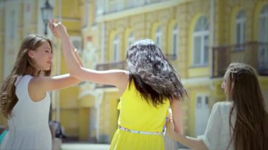 Üç modaya uygun kız, her biri neşe saçan, hareketli bir caddede geziniyor, alışveriş torbaları heyecandan sallanıyor. Sahne onların kaygısız ruhlarını ve dostluklarını yakalar. Başarılı bir alışveriş çılgınlığının heyecanını kucaklarlar.