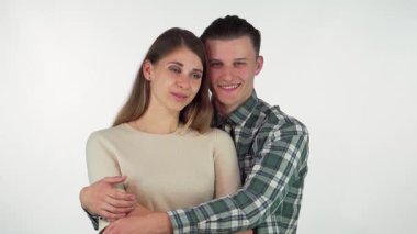 Mutlu, yakışıklı bir adam, güzel kız arkadaşının kollarına sarılıyor. Sıcak bir stüdyo ortamında sevgi ve neşe saçıyor. Gülüşleri derin bir bağı yansıtıyor, şefkatli ilişkilerinin sıcaklığını gösteriyor.