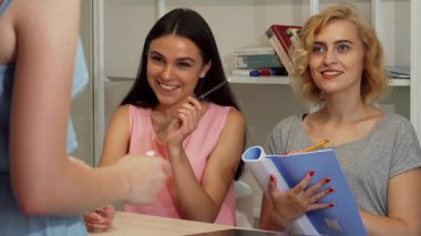 Canlı bir sahnede, iki genç iş kadını bir toplantı sırasında fikirleri tartışırken, coşkularını ve yaratıcılıklarını sergilerken görülüyor. Kitaplar ve notlarla dolu modern ofis ortamı, yeniliklerin olduğu işbirlikçi bir atmosferi yansıtıyor.