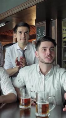 Enerjiyle dolu canlı bir barda, dört canlı iş adamı, buzlu bira bardaklarını kaldırır, televizyonda heyecan verici bir maç izlerken tezahürat ve tezahürat yaparlar. Hayat dolu atmosfer yoldaşlık ve neşe ile uğulduyor.