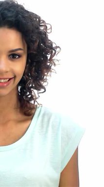 Büyüleyici kıvırcık saçlı Afro-Amerikalı bir kız yukarı doğru işaret ederken neşe saçıyor, pozitiflik ve ilham saçıyor. Parlak gülüşü ve ışıl ışıl gözleri çekici bir portre oluşturuyor, gençlik cazibesini sergiliyor, beyaz bir arka plana karşı.