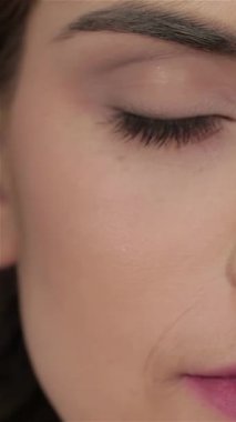 Bu zarif yakın plan portre kusursuz, pırıl pırıl bir cilde sahip büyüleyici yeşil gözleri canlılıkla parlayan bir kadını gösteriyor. Yumuşak, doğal makyaj onun gençlik cazibesini vurguluyor, güzellik ve cilt mükemmelliğinin özünü somutlaştırıyor.