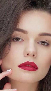 Bu büyüleyici portre, parlak esmer saçlı ve koyu kırmızı dudaklı, parlak siyah arka planda kendine güveni olan genç beyaz bir kadını sergiliyor. Kusursuz cildi ve yüzüne dokunuşu saflık ve zarafeti çağrıştırıyor.