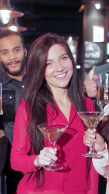 Canlı bir grup genç arkadaş neşeli bir kadeh kaldırarak neşeli bir barda içkilerini yudumluyor, samimiyet ve dostluk yayıyorlar. En sevdikleri futbol takımı için tezahürat yaparken atmosfer kahkaha ve heyecanla uğulduyor.