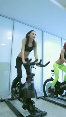 Canlı bir sahne, sabit bisiklete binip, spor ve sağlığa olan bağlılıklarını somutlaştıran beş formda arkadaşı çekiyor. Moda spor kıyafetleriyle giyinmiş, kararlı ifadeleri ve senkronize hareketleri heyecan verici bir titreşim yayıyor.